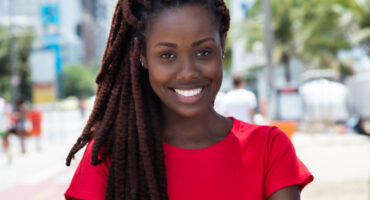 Awesome african woman with dreadlocks outdoor in city in summer