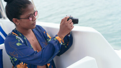 African Woman Using Camera In A Boat